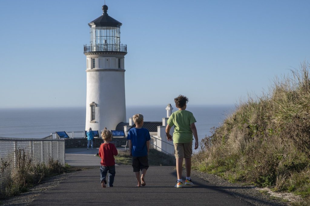 Kids visiting a Cape Disappointment Lighthouse in Long Beach, WA, one of the best things to do with kids in the area.